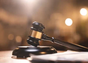 a wooden legal gavel and case documents on a desk, representing defense strategies from a domestic assault lawyer in fort bend county.